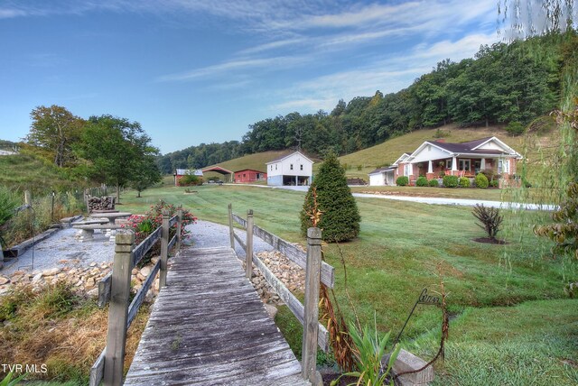 view of dock with a yard