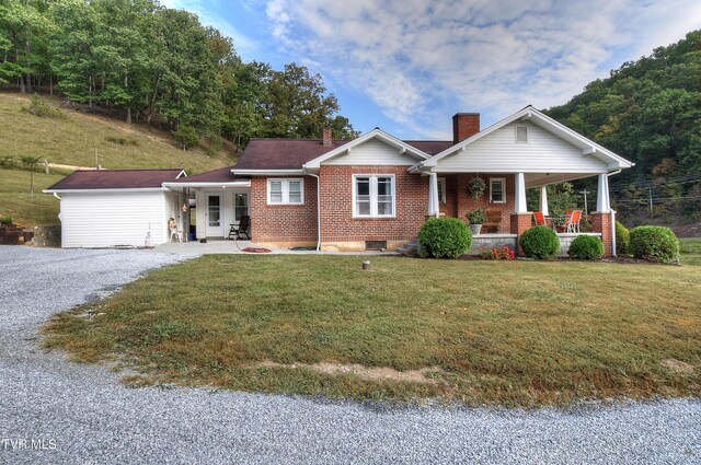 view of front of home featuring a front yard and a porch