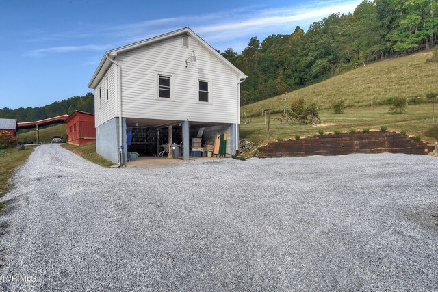 view of side of home featuring an outdoor structure