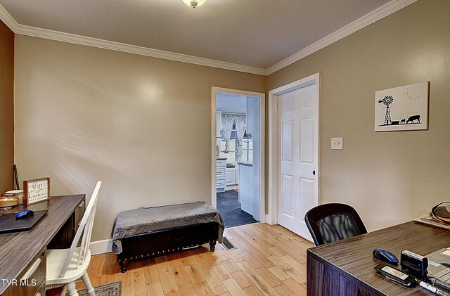 office space with light wood-type flooring and crown molding