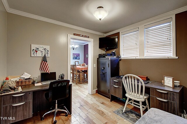 home office with light hardwood / wood-style floors, ornamental molding, and a notable chandelier