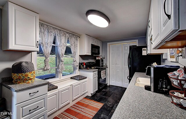 kitchen featuring black appliances, dark hardwood / wood-style floors, and white cabinetry