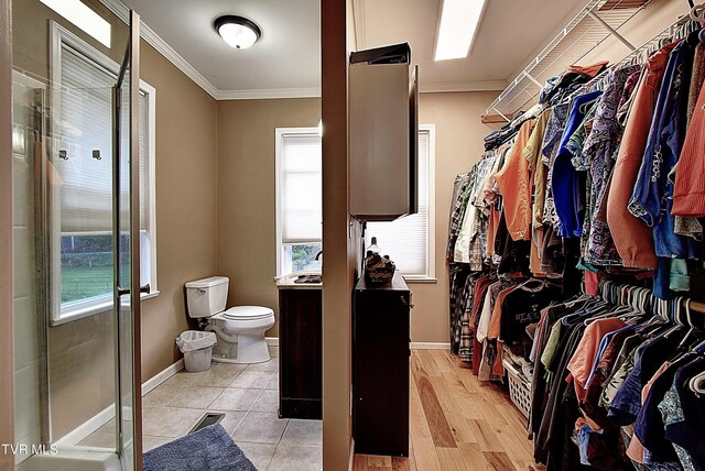 walk in closet featuring light hardwood / wood-style flooring