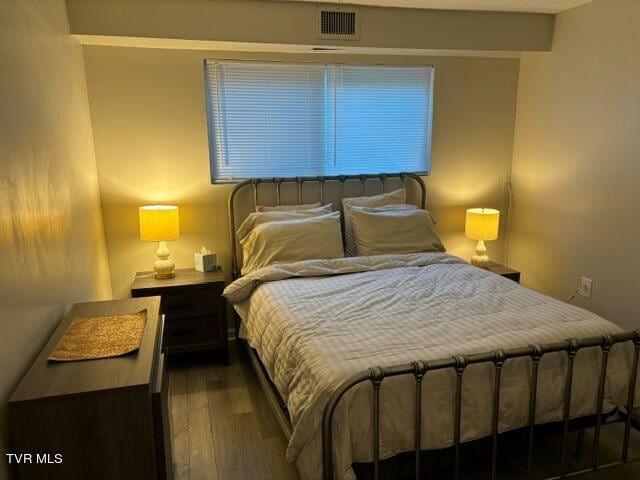 bedroom with wood finished floors and visible vents