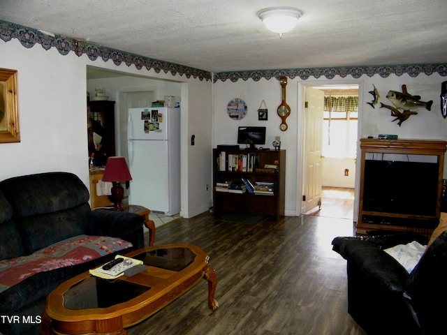 living room featuring a textured ceiling and hardwood / wood-style floors