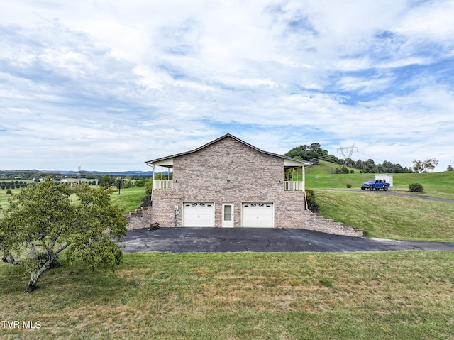 view of side of home with a yard and a garage