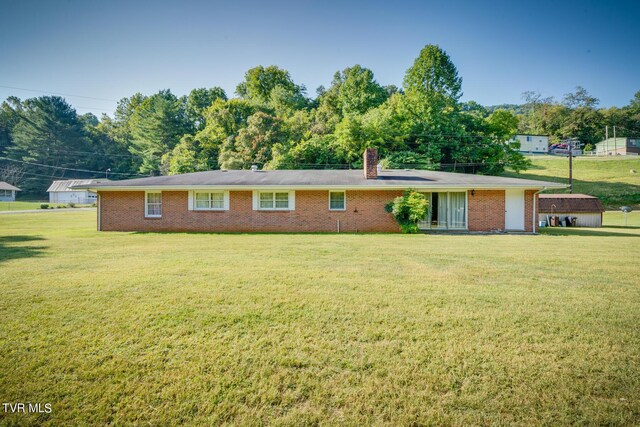 back of house with a yard