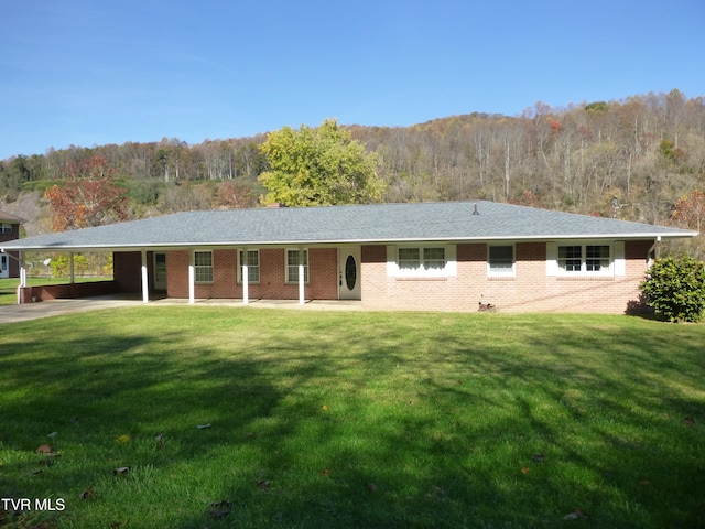 ranch-style house featuring a front yard and a carport