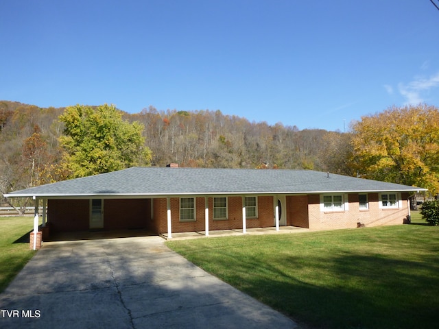 single story home with a front lawn and a carport