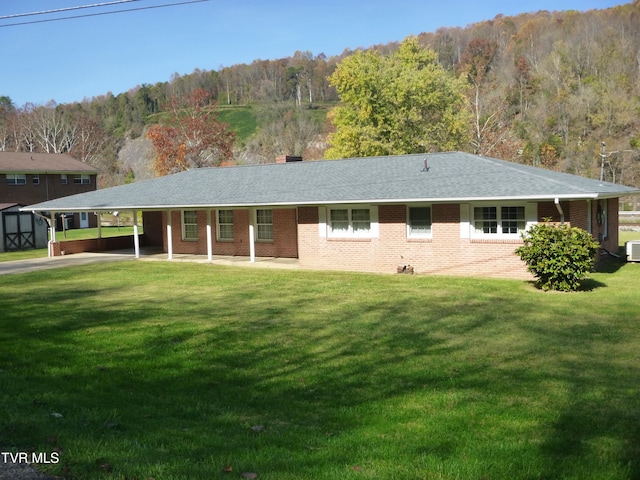 ranch-style home featuring a front yard and a carport