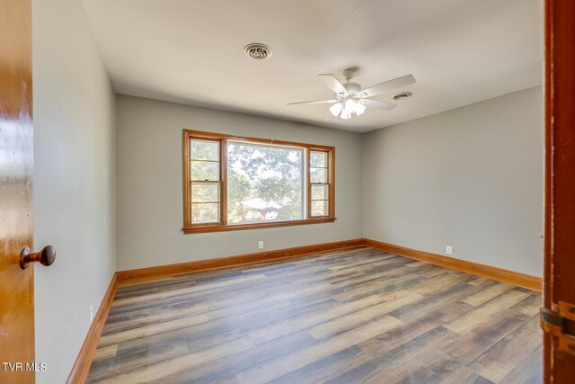 empty room featuring hardwood / wood-style floors and ceiling fan