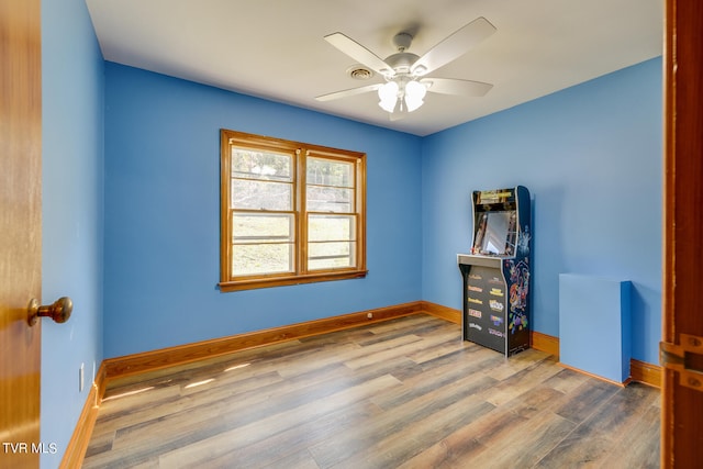 spare room with ceiling fan and hardwood / wood-style floors