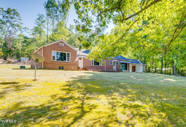 single story home with brick siding and a front yard