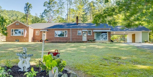 single story home with a carport, brick siding, a chimney, and a front lawn