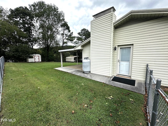 view of yard with a patio and a shed