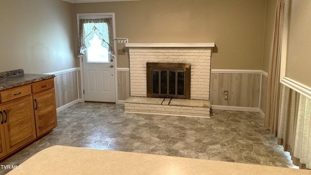 unfurnished living room with a brick fireplace