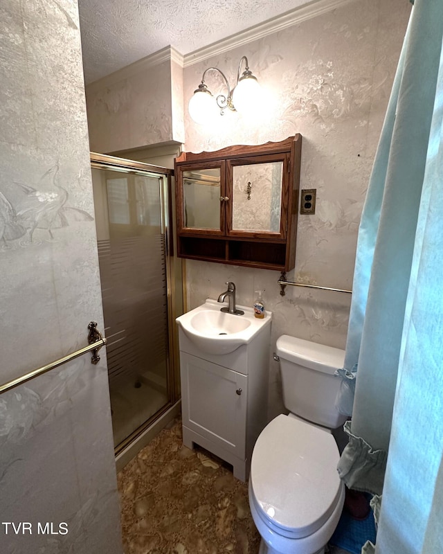 bathroom with a textured ceiling, vanity, toilet, and an enclosed shower