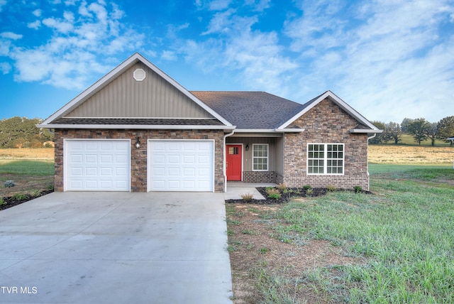 view of front of property with a garage and a front lawn