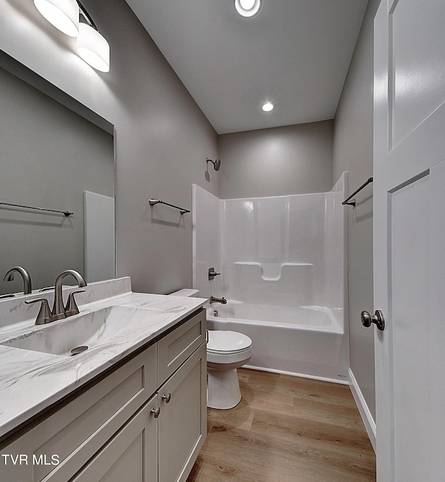 full bathroom with vanity, toilet, shower / bath combination, and hardwood / wood-style floors