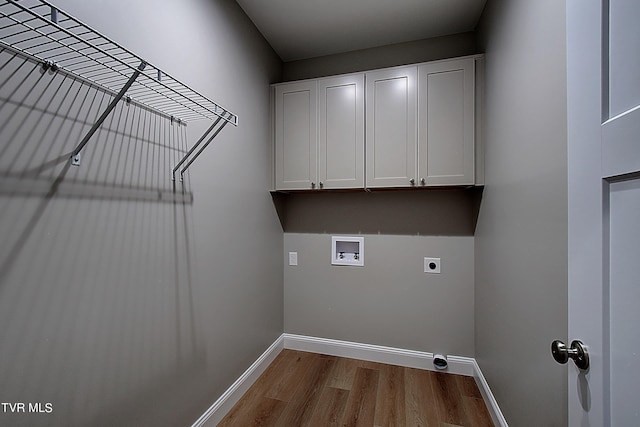 washroom with hookup for a washing machine, light hardwood / wood-style flooring, cabinets, and electric dryer hookup