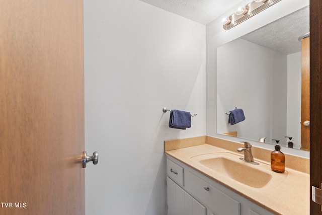 bathroom with vanity and a textured ceiling