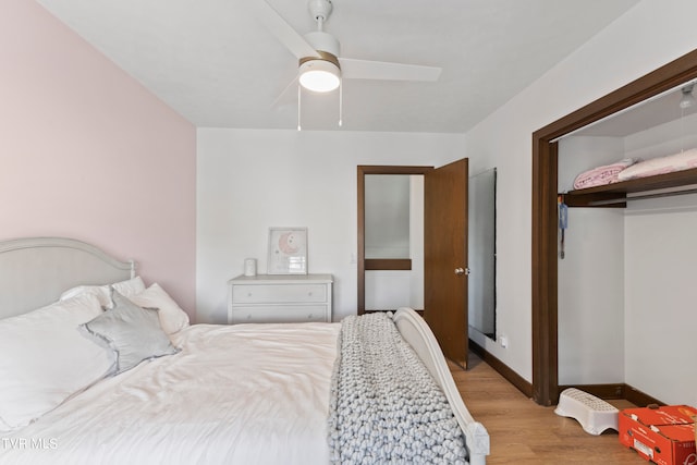 bedroom with hardwood / wood-style floors, ceiling fan, and a closet