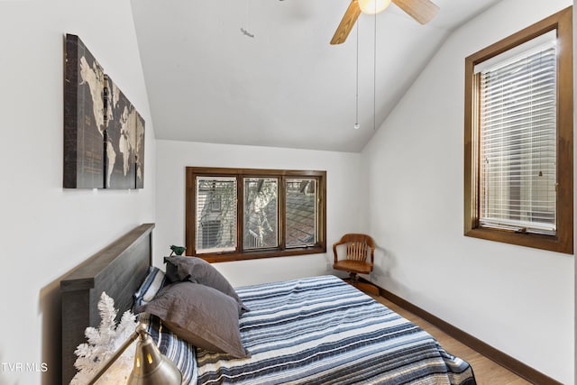 bedroom with hardwood / wood-style floors, ceiling fan, and lofted ceiling