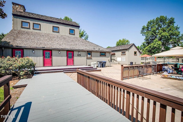 wooden deck with a patio area