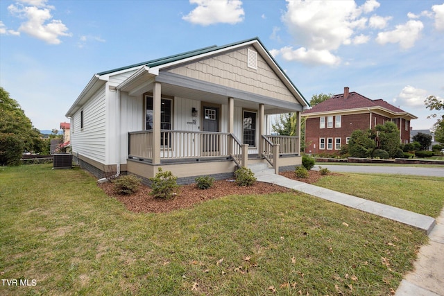 view of front of property featuring a front yard, central AC, and covered porch