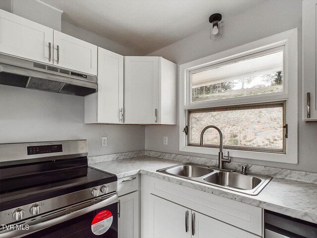 kitchen with sink, stainless steel appliances, and white cabinets