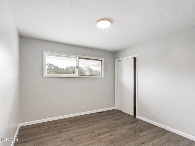 empty room featuring dark wood-type flooring