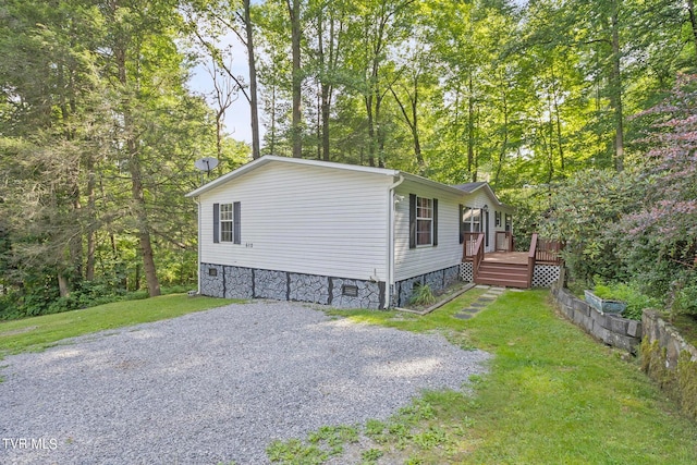 view of side of property with a lawn and a deck