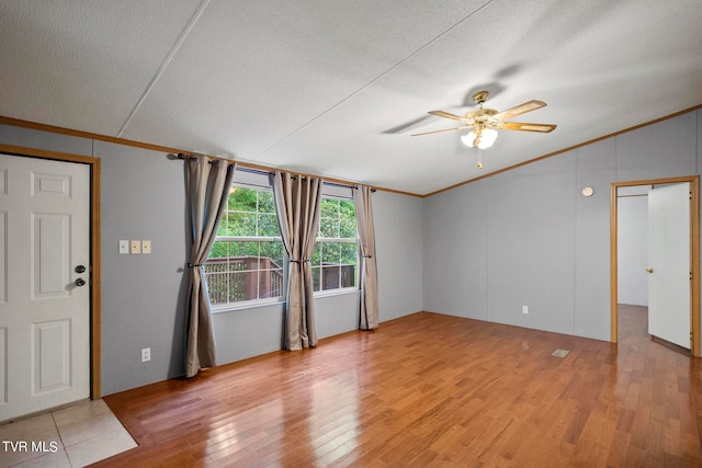 spare room with light wood-type flooring, ceiling fan, and ornamental molding