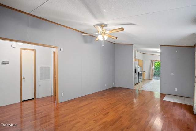 unfurnished room with light wood-type flooring, crown molding, ceiling fan, and a textured ceiling