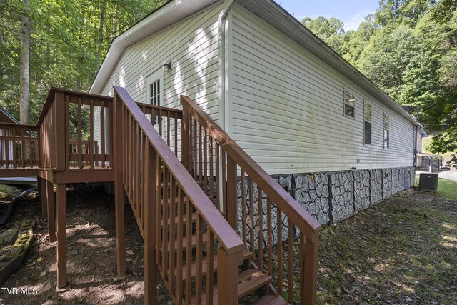 rear view of house featuring cooling unit and a deck