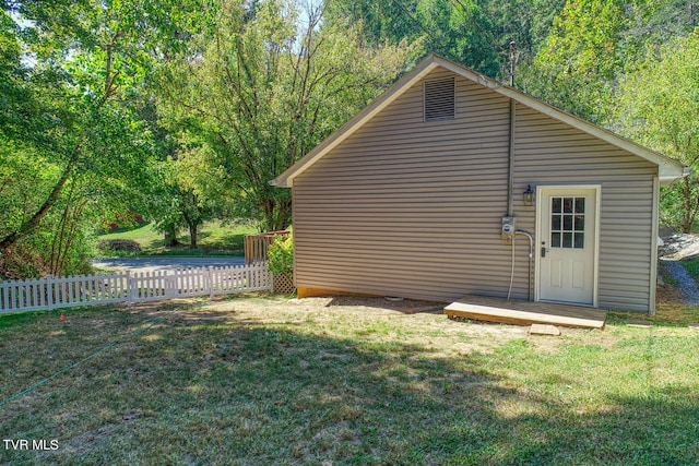 exterior space featuring a yard and a wooden deck