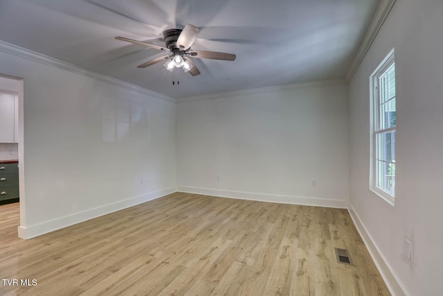 spare room with crown molding, ceiling fan, and light hardwood / wood-style floors