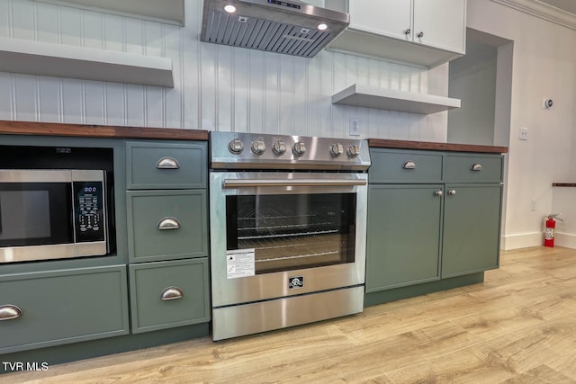 kitchen featuring range hood, appliances with stainless steel finishes, light hardwood / wood-style floors, white cabinetry, and ornamental molding