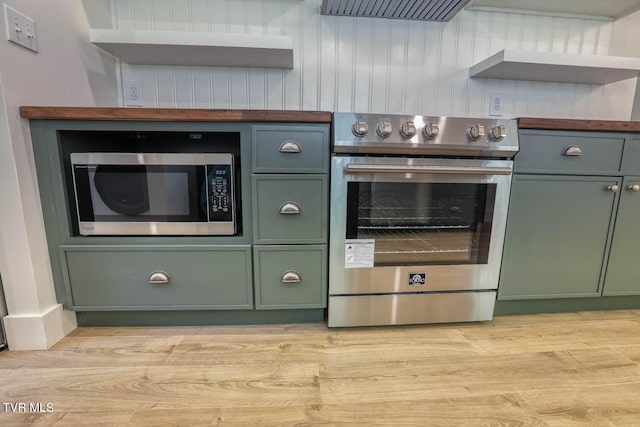 kitchen with appliances with stainless steel finishes and light hardwood / wood-style flooring