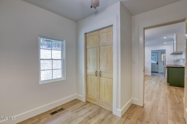 bedroom with light wood-type flooring and a closet