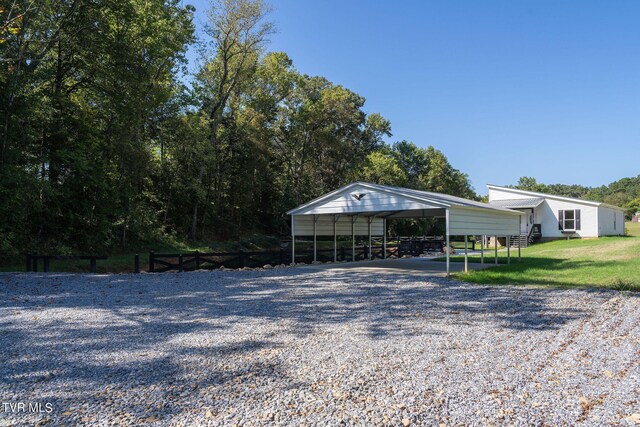 exterior space with a carport and a front lawn