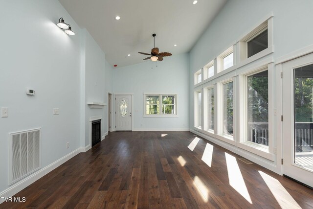 unfurnished living room featuring high vaulted ceiling, ceiling fan, and dark hardwood / wood-style floors