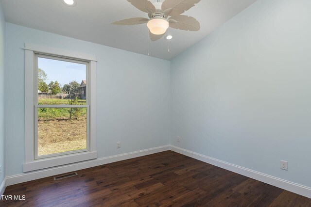 unfurnished room featuring lofted ceiling, ceiling fan, a healthy amount of sunlight, and dark hardwood / wood-style flooring