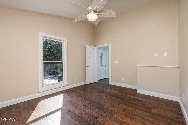 unfurnished room featuring dark wood-type flooring and ceiling fan