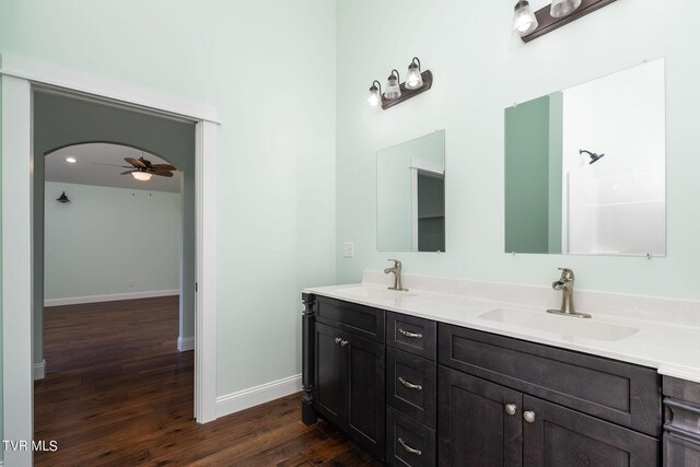 bathroom with hardwood / wood-style floors, ceiling fan, and vanity