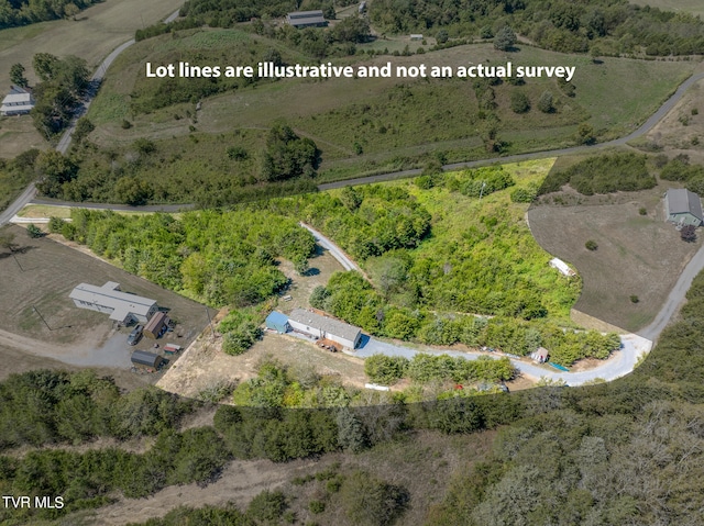 birds eye view of property with a rural view