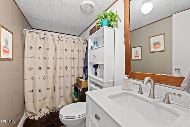 bathroom featuring vanity, toilet, and a textured ceiling