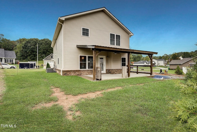 back of house with cooling unit, a lawn, and a patio