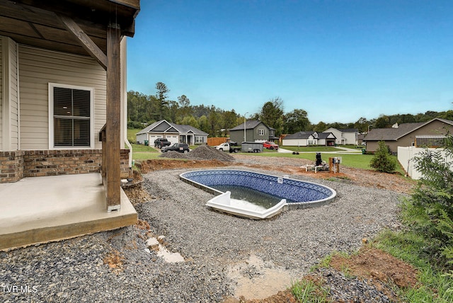 view of pool featuring a lawn