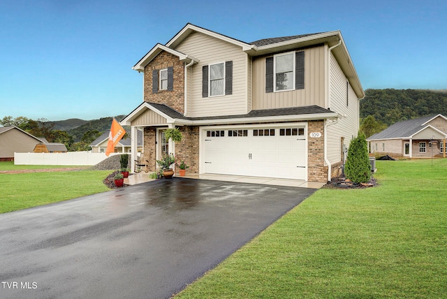 craftsman house featuring a garage and a front lawn